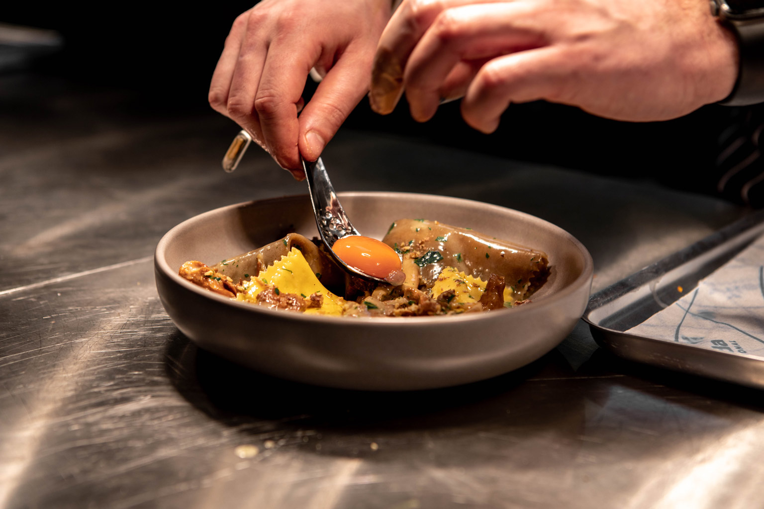 Chef plating up the silk hankerchiefs pasta